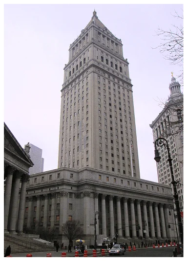 Elegant skyscraper towers over neoclassical courthouse, surrounded by pedestrians and traffic cones on a cloudy day in New York City.